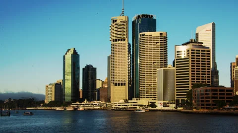 Time-lapse of a large city skyline at sunrise, ferries on harbour NTSC 102GYBSD Stock Footage 26321779