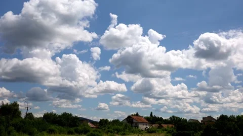 Time lapse of large clouds over a picturesque town in the mountains Stock Footage 278618376