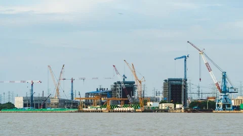 Time Lapse Large construction By the river with crane work. Stock Footage 115930849
