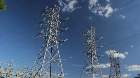 Time lapse - Large high-voltage transmission lines. Clouds passing by lines. Stock Footage 911099