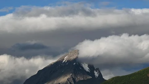 Time lapse of a large rocky mountain with clouds forming  Stock Footage 279657580