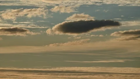 Time lapse of late day clouds moving at different speeds in a pale blue sky Stock Footage 289547629