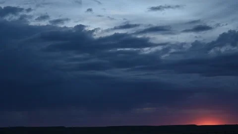 Time lapse of a late day orange colored sunset in a flat prairie badlands  Stock Footage 279096977