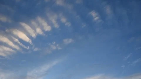 Time lapse of late day summer clouds move across a blue summer sky Stock Footage 319595757