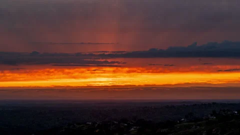 Time Lapse of Layered Sunset Fading from Red and Gold to black and Grey Stock Footage 278481599