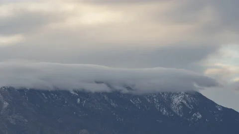 Time lapse of a lenticular cloud forming over desert mountains Stock Footage 235542295