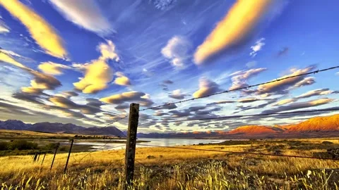 Time-Lapse of Lenticular Clouds Over a Rural Lake at Sunset Stock-Footage 341210363