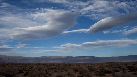 Time lapse of lenticular saucer clouds in blue sky in the Owens Valley desert Stock Footage 114739848