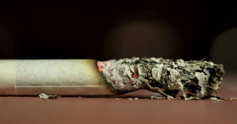 Time lapse Light a cigarette and smoke on a black background. Stock Footage 186964695
