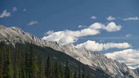 A time lapse of a light grey mountain ridge with white clouds Stock Footage 139466630