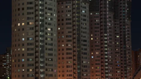 Time lapse of light in the windows of buildings at night. Stock Footage 168961869