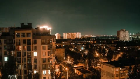 Time lapse of lightning strikes above city buildings during a heavy storm, at Stock Footage 156408819