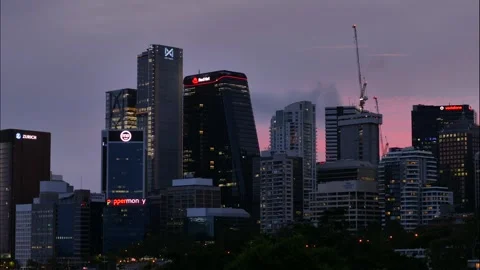 Time lapse lights come on in skyscraper swindows from evening to night 4K Video stock 262213342
