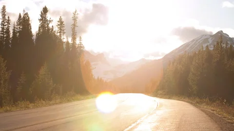 Time Lapse Lockdown Shot Of Vehicles Moving Amidst Forest By Snowy Mountains Stock Footage 160329829