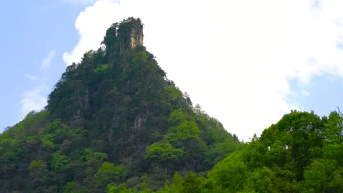 Time Lapse of Lone Green Mountain Peak Top Flow Cloud Clear Sky Video stock 337942068