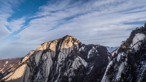 Time Lapse of Long Fluffy Cloud Sunny Main Peak Rock Wall Stock Footage 337938192