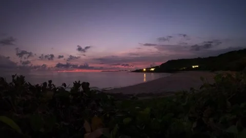 Time-lapse look out to the ocean beach side coastline city light calm water with Stock Footage 280568356
