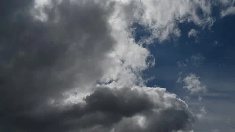 A time lapse that is looking up at building storm clouds in a partly blue sky.  Stock Footage 279096807