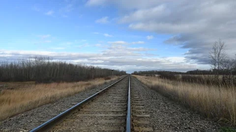 Time lapse looking down a railroad track with dry grass moving quickly Stock Footage 221502726