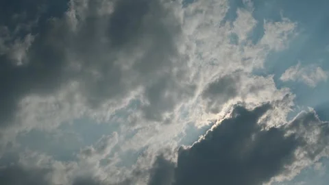 Time lapse looking up at dramatic white and gray summer clouds moving through a Stock Footage 333074897