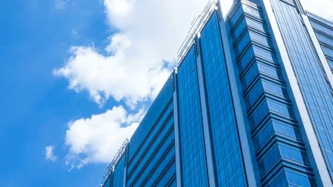 Time lapse, looking up at a glass-covered skyscraper Video stock 78717339
