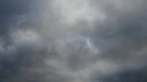 A time lapse looking up at light to dark gray clouds moving from left to right.  Stock Footage 259220626