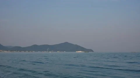 Time lapse looking out to sea with mountains in the background 스톡 동영상 60807751