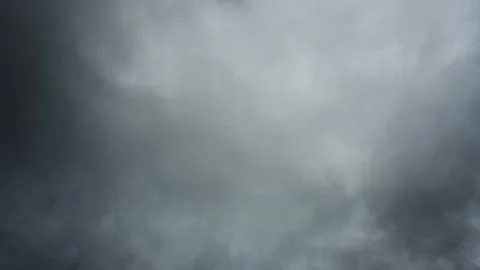 Time lapse looking up into a sky filled with stormy clouds as they churn and swi Stock Footage 321199371
