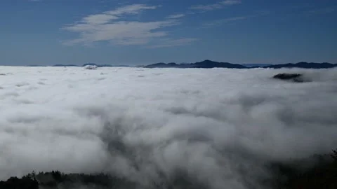 Time lapse low altitude inversion clouds rolling in valley Stock Footage 140803469