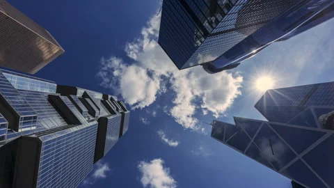 Time-lapse of low angle view skyscraper building in Hong Kong blue sky 스톡 동영상 250616455