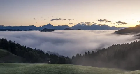 Time lapse low inversion clouds rolling in Alpine valley Stock Footage 140801478