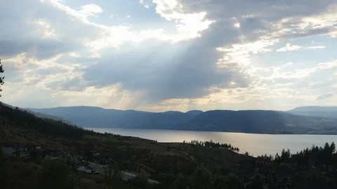 Time lapse of luxury mountain overlooking lake with glittering clouds 4k. Stock Footage 96493583
