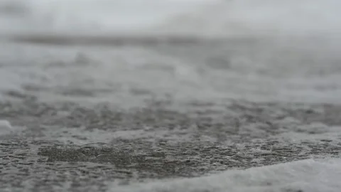 Time lapse macro ground level closeup view of rock salt ice-melt on concrete Stock Footage 226865519