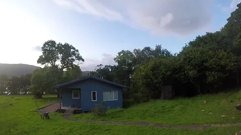 Time lapse of magnificent billowing clouds swept past the setting sun over a Stock-Footage 80100316