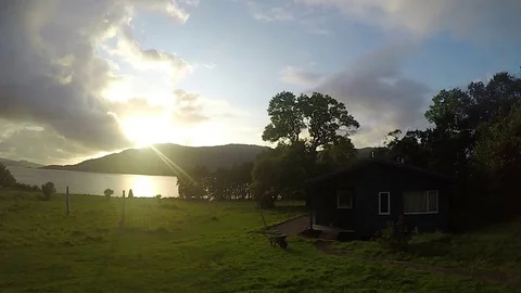 Time lapse of magnificent clouds swept past the setting sun over a lonely Stock-Footage 79884958