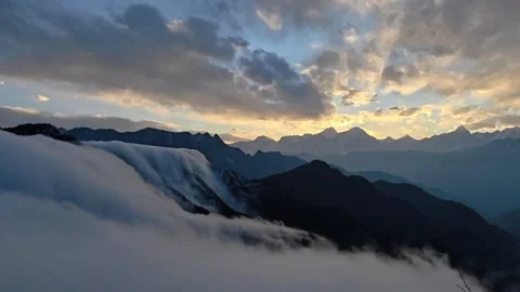 Time-lapse of Majestic Cloud Waterfall and Snow Mountains at Sunset Stock Footage 329005902