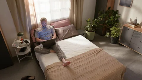 Time Lapse of Male Freelancer Waking up in Morning and Working on Laptop on Bed Stock Footage 314838451