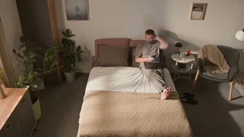 Time Lapse of Male Freelancer Working on Laptop on Bed then Sleeping at Night Stock Footage 314839401