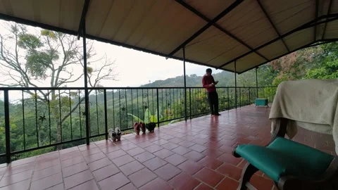 Time lapse of Man on Balcony in Vacations 動画素材 329528709
