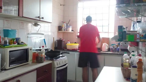 Time lapse of a man cleaning a kitchen in brazil Stock Footage 130677163