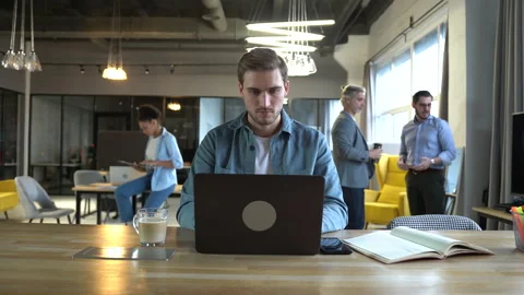 Time-lapse of man employee working in office using laptop while coworkers moving Stock Footage 171789408