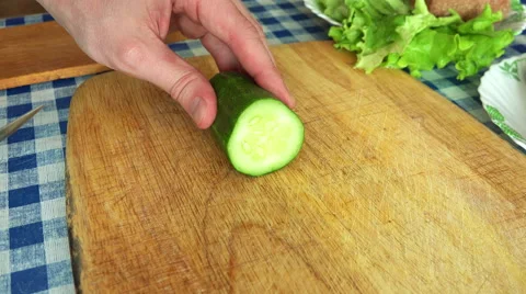 Time Lapse of Man Slicing Cucumber on a Kitchen Table Stock Footage 49912962