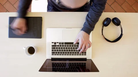 Time lapse of man working from home with his laptop on a wooden desk. Top view Stock Footage 127641987