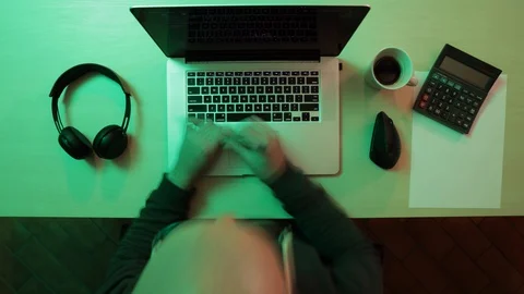 Time lapse of man working from home with his laptop on a wooden desk. Top view Stock Footage 127658023