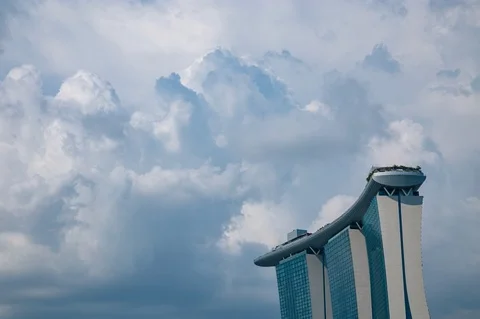 Time Lapse Massive Clouds Developing Over Beautiful Modern Marina Bay Sands Stock Footage 99977369