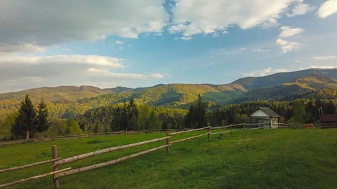 Time lapse of massive clouds moving over mountains. Sun shines through clouds Stock Footage 129980907
