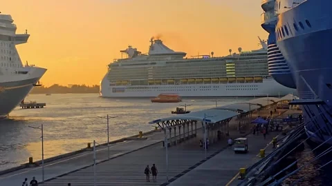 Time-lapse of a massive cruise ship departing a busy port at sunset Stock Footage 341908034