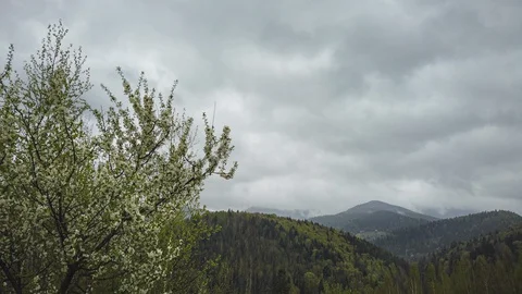 Time lapse of massive rainy clouds moving over the mountains Stock Footage 129812410