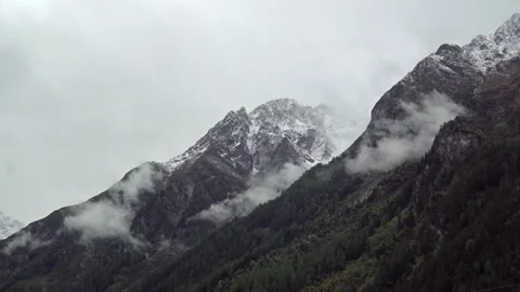Time Lapse of massive snow-capped mountain peaks of alpine mountains in clouds Stock Footage 120702186