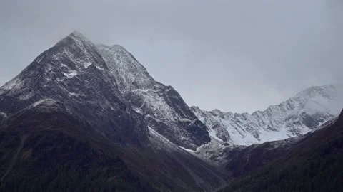 Time Lapse of massive snow-capped mountain peaks of alpine mountains in clouds Stock-Footage 120702279
